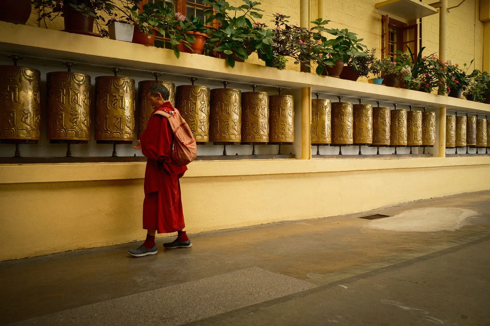 A monk turning the prayer wheels at a temple in Dharamshala