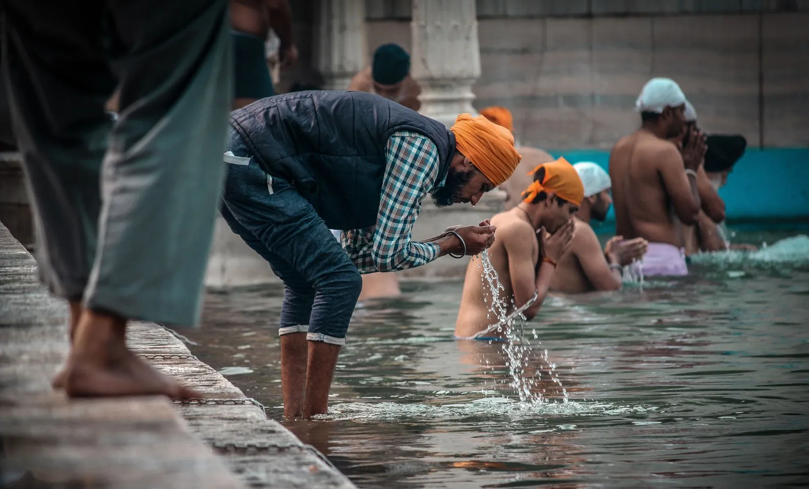 Sikh men bathing in the sacred pool of the Golden Temple, Amritsar