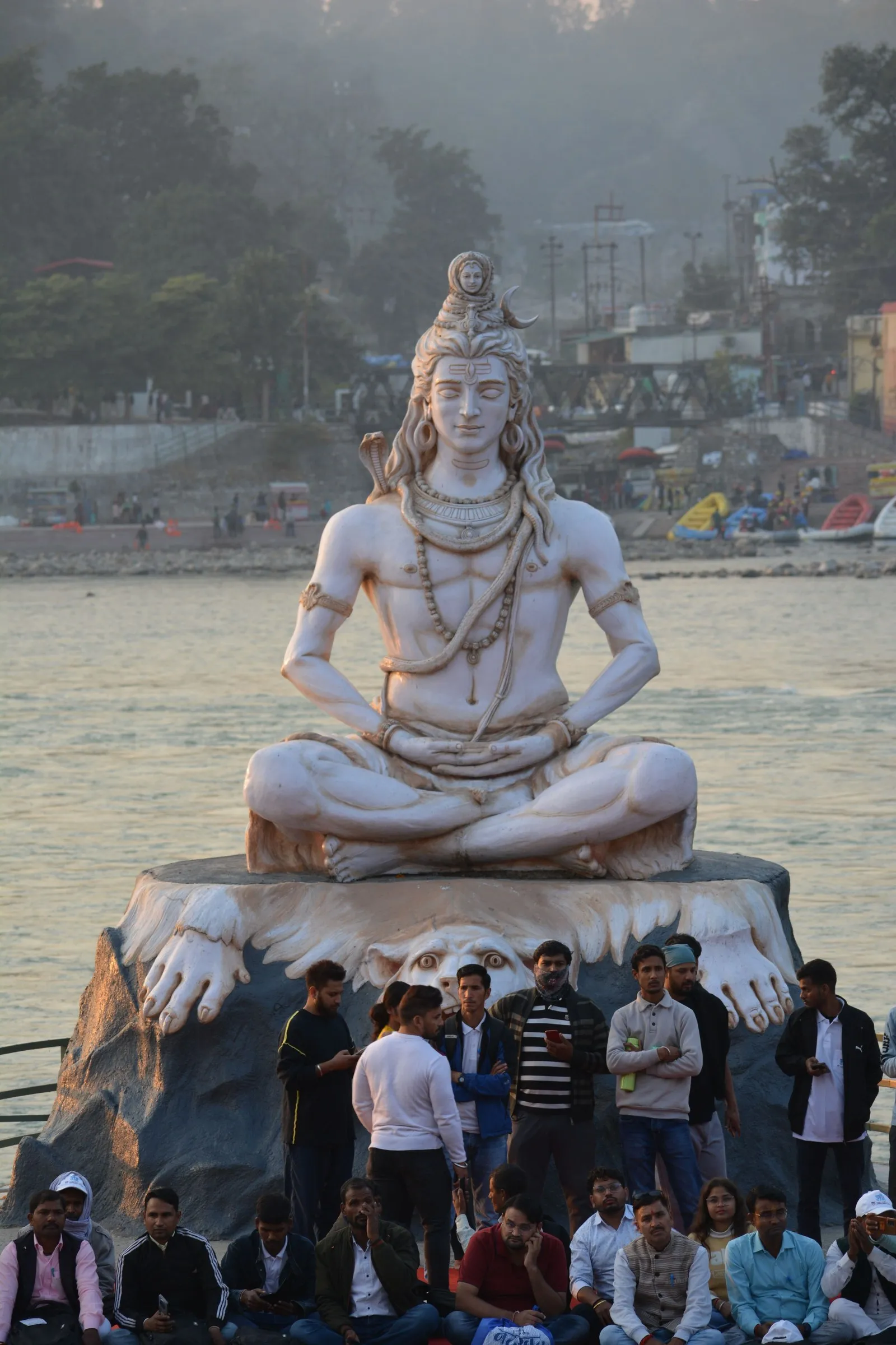 The white statue of Shiva on the Ganga at Rishikesh, pilgrims below